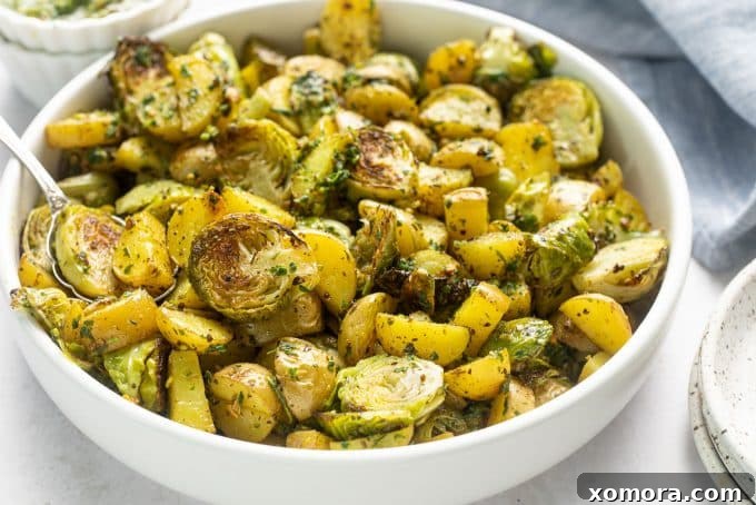 A close-up of a serving of pesto potatoes and brussels sprouts