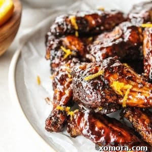 A dish of sticky orange balsamic chicken wings ready to serve.