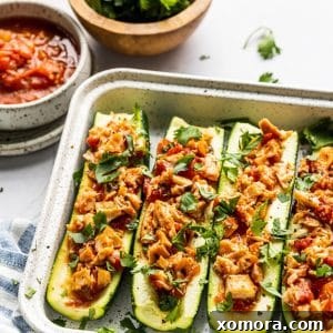 A dish of Salsa Chicken Zucchini Boats.