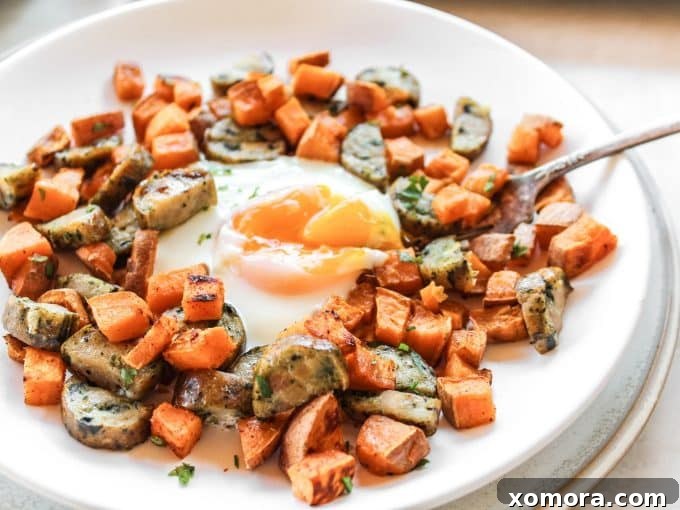 Sweet potatoes and sausage roasting on a sheet pan for breakfast.