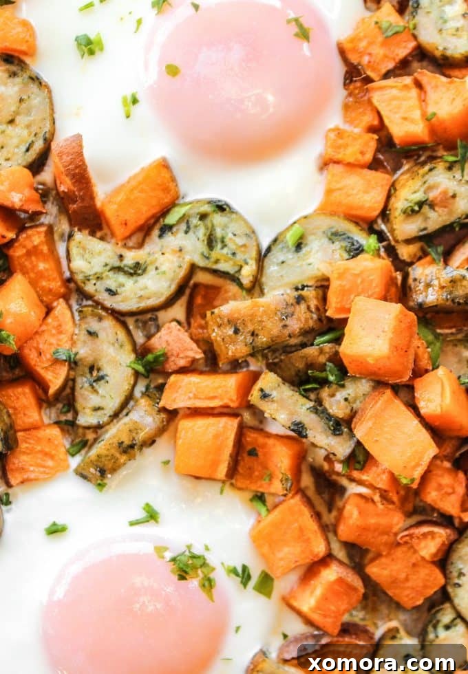 Sheet Pan Sweet Potato Breakfast with cooked eggs and fresh parsley garnish.