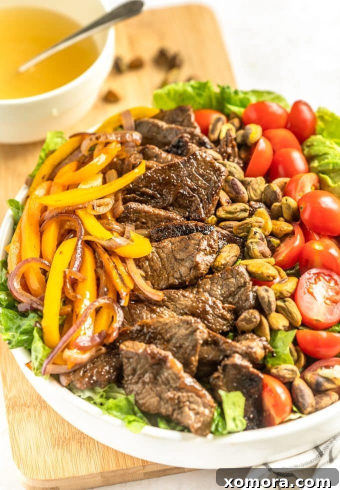 Fiesta Steak Salad with Citrus Vinaigrette 2 A vibrant Southwestern Steak Salad with juicy steak slices, colorful bell peppers, red onion, avocado, cherry tomatoes, and fresh cilantro, drizzled with lime vinaigrette.