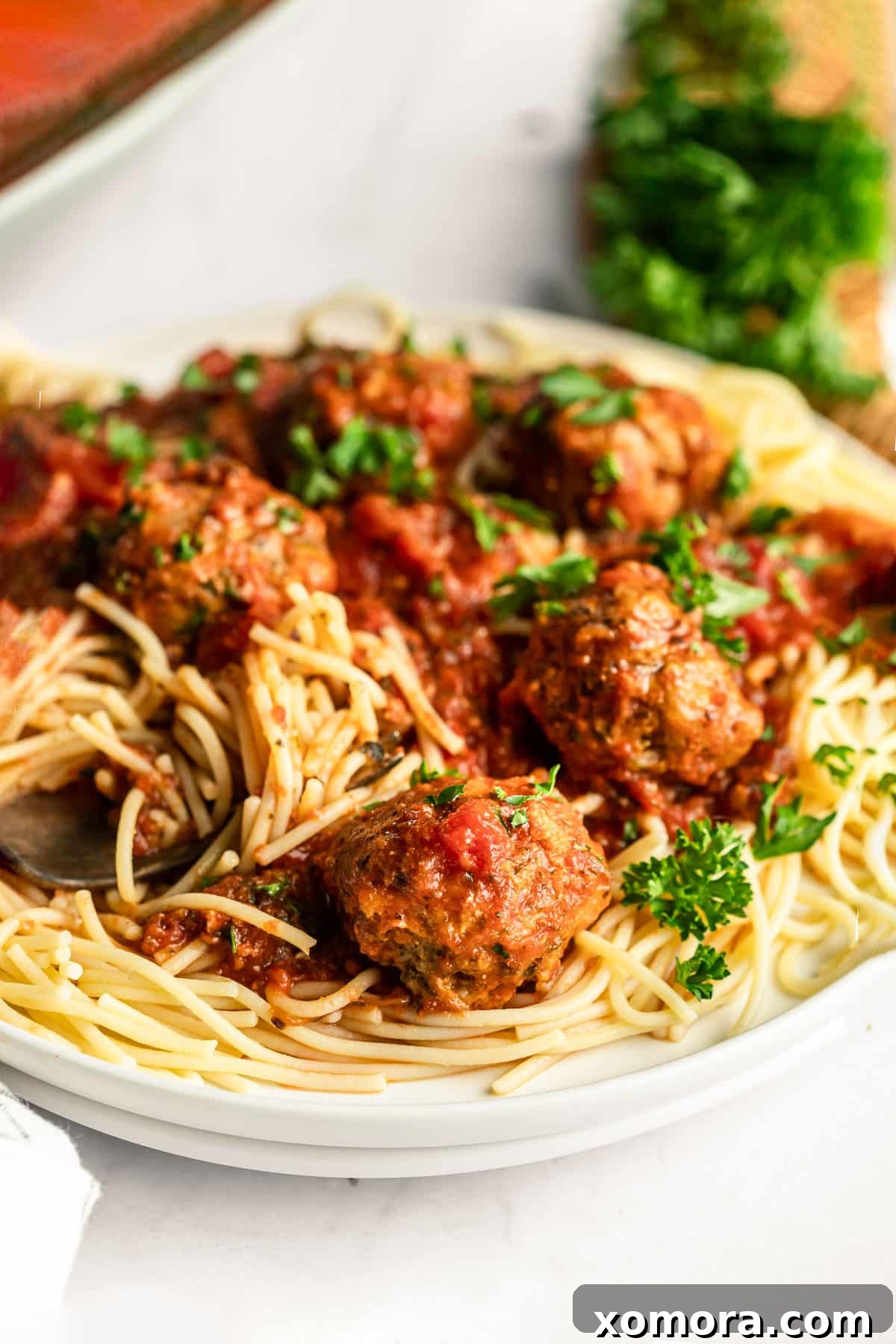 Mouthwatering Slow Cooker Turkey Meatballs in Classic Marinara 5 Plate of slow cooker turkey meatballs in marinara sauce, garnished with fresh herbs.