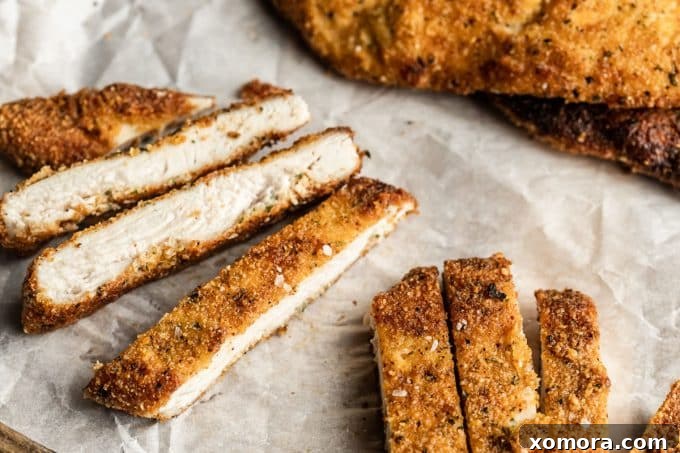 Crispy Almond Chicken Cutlets 3 Ingredients for almond flour chicken cutlets laid out: chicken breasts, almond flour, eggs, olive oil, and various spices.