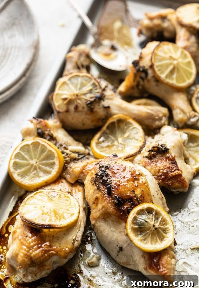 Golden Lemon Herb Roast 3 Lemon herb roasted chicken pieces, showing the golden skin and tender meat, ready to be served.