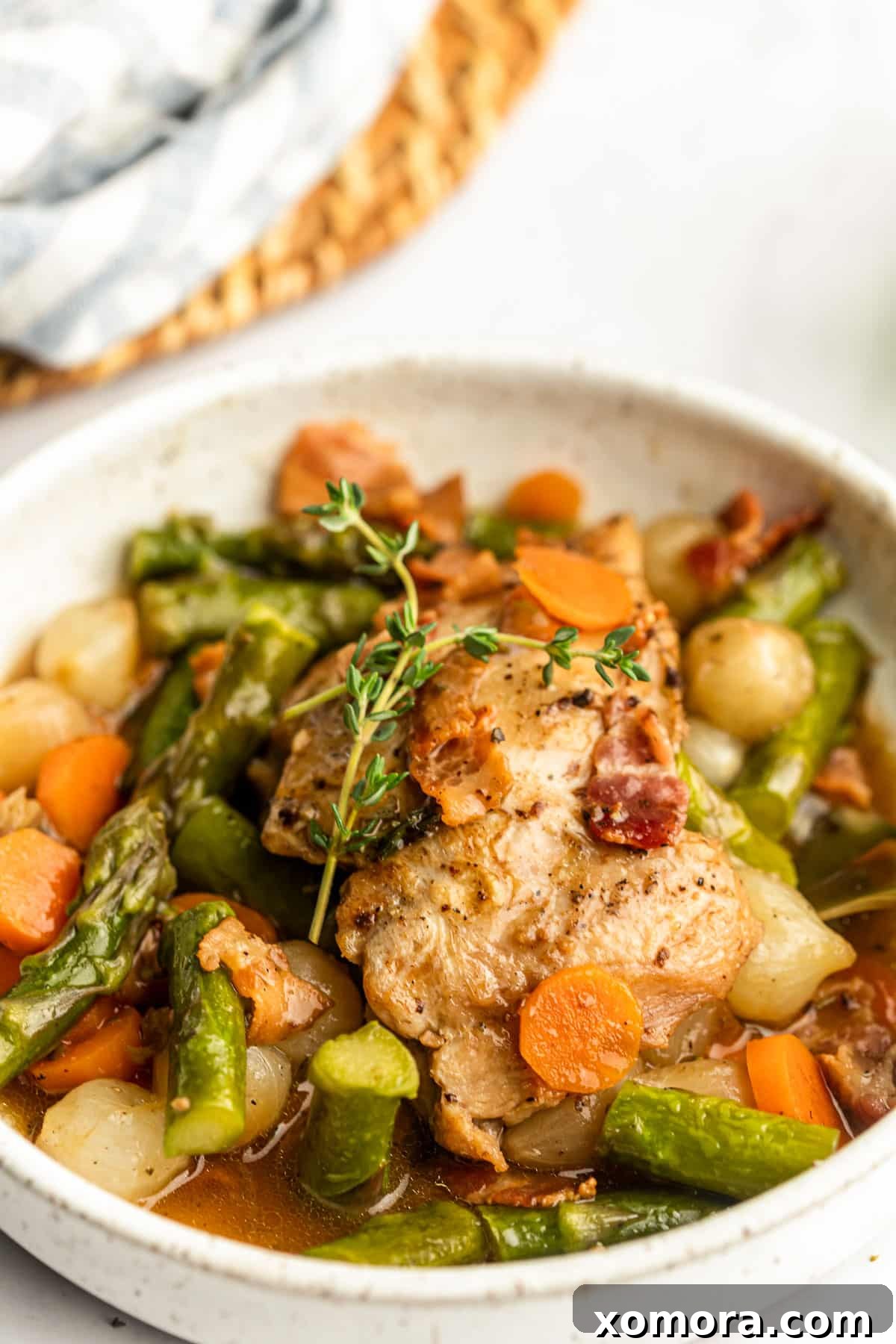 Close-up of golden brown chicken thighs sizzling in a skillet before adding other ingredients.