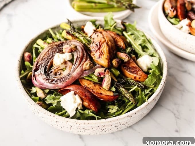 Summer Peach Arugula with Balsamic 6 A close-up shot of the finished Balsamic Peach Arugula Salad in a bowl, highlighting the textures and vibrant colors.