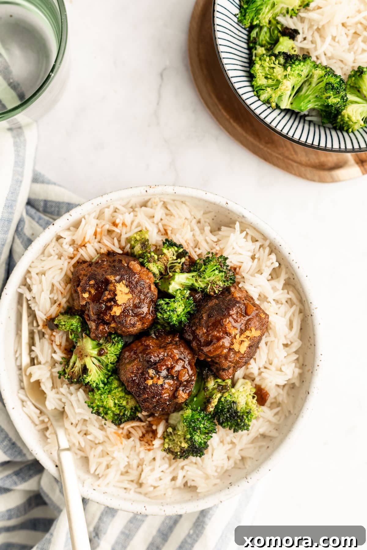 Zesty Orange Balsamic Glazed Meatballs 2 Orange Balsamic Meatballs served as an appetizer with a garnish of fresh parsley