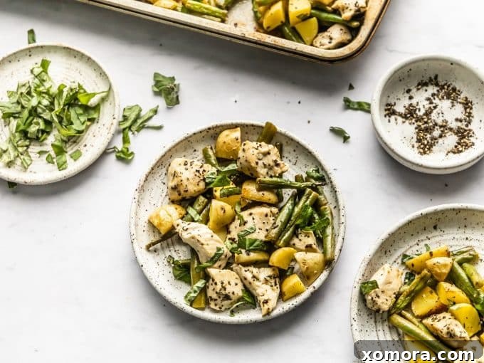 Roasted potatoes on a sheet pan, showing their tender and slightly crispy texture.