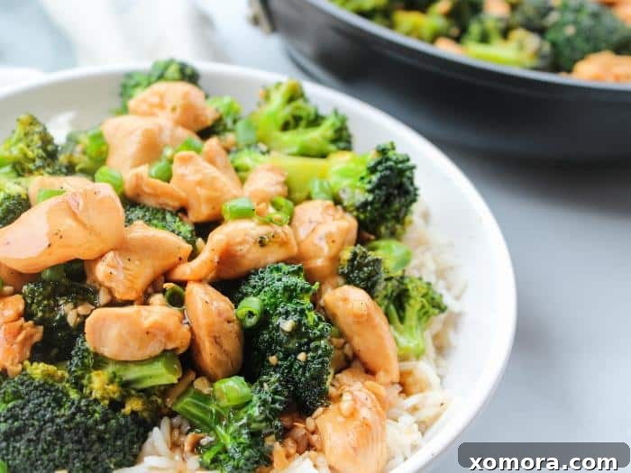 Savory Teriyaki Chicken and Broccoli Stir-Fry 5 A bowl of Teriyaki Chicken and Broccoli served over white rice with chopsticks.