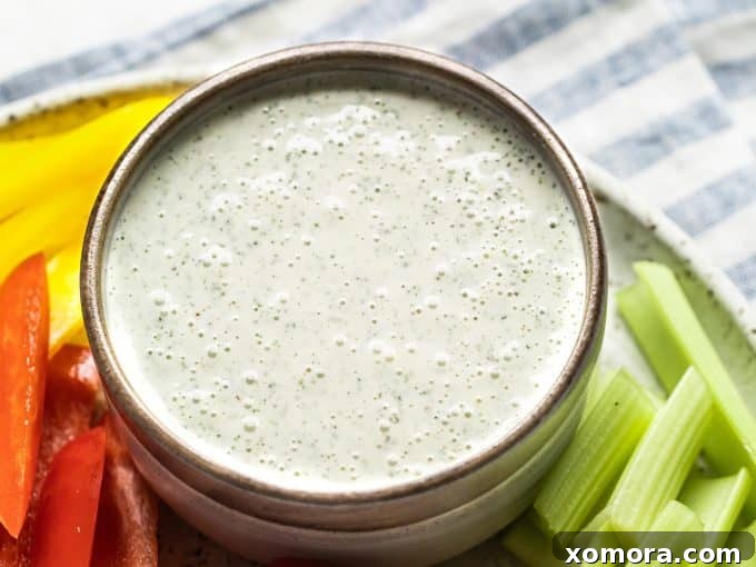 Plant-Based Ranch Dressing and Dip 4 Ingredients for Dairy-Free Ranch Dressing laid out on a table, including mayo, olive oil, coconut milk, and various herbs and spices.