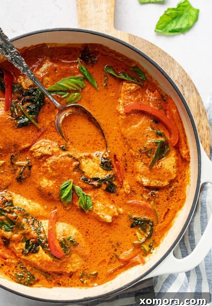 Creamy Red Pepper Chicken Sauté 5 A close-up of Sautéed Chicken in Creamy Red Pepper Sauce, perfectly plated with fresh basil garnish.