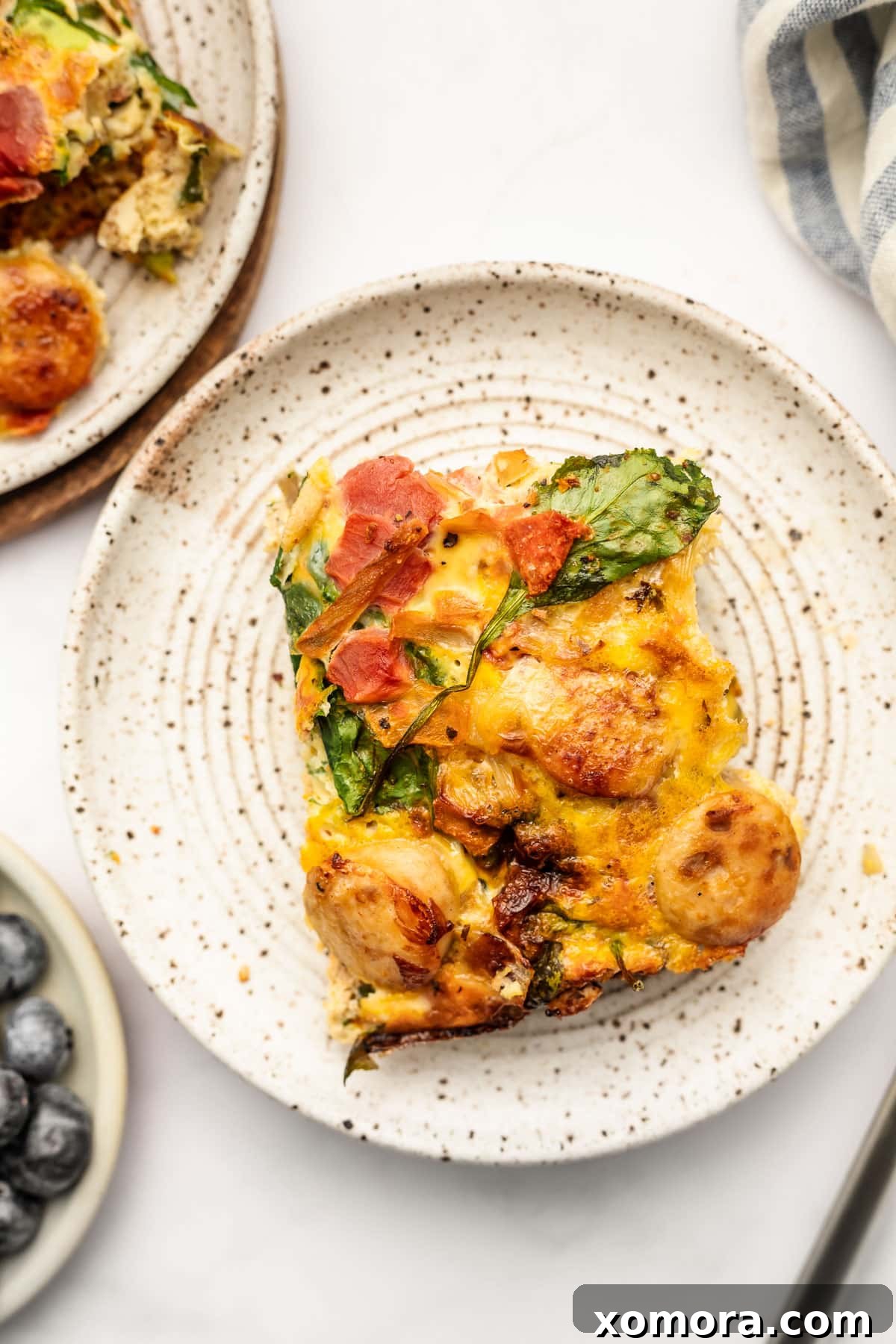 Several slices of dairy-free chicken sausage breakfast casserole arranged on a serving plate, ready to be enjoyed with a fork.