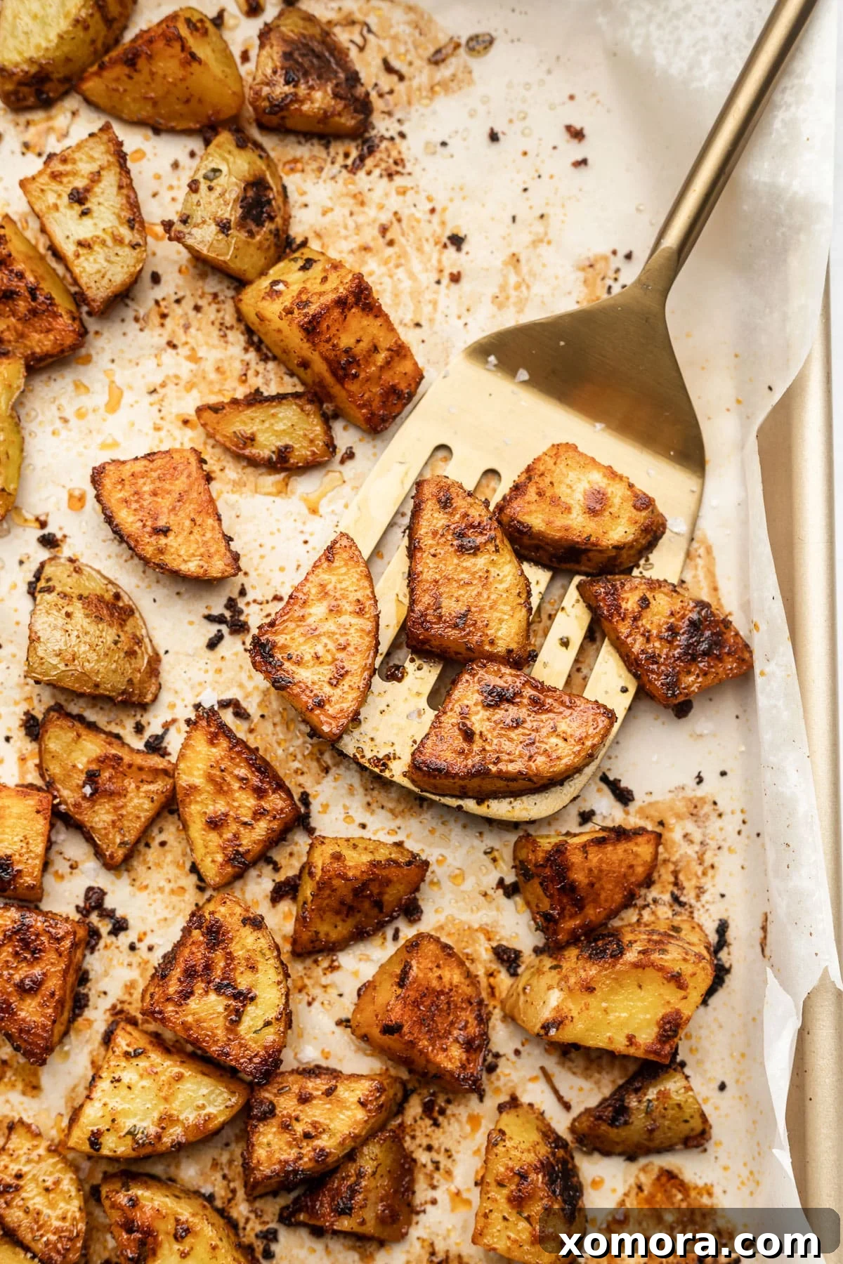 Golden Crispy Oven Potatoes 5 A serving of crispy roasted potatoes in a bowl.