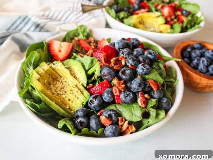 Vibrant Berry Avocado Salad 3 Close-up of the vibrant berry avocado salad, showcasing the fresh berries, creamy avocado, and green leaves.