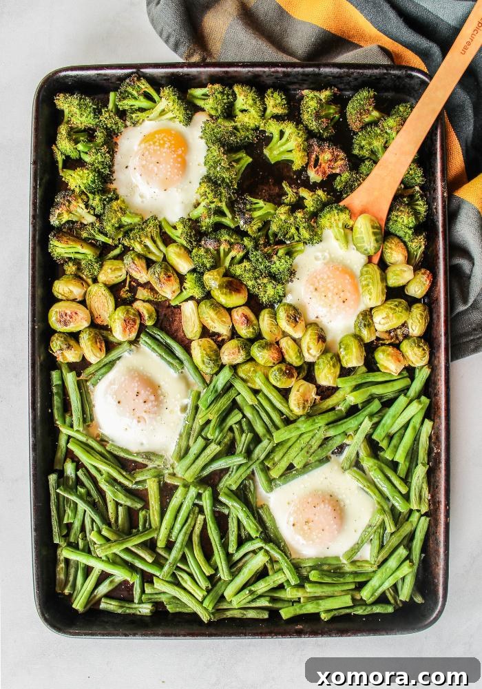 One Pan Veggie Breakfast Bowls 2 Vibrant Sheet Pan Veggie Breakfast Bowl with roasted broccoli, brussels sprouts, green beans, and baked eggs, ready to be enjoyed.