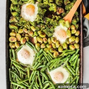 One Pan Veggie Breakfast Bowls 4 A beautifully plated Sheet Pan Veggie Breakfast Bowl, showcasing roasted vegetables and baked eggs.