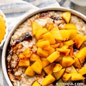 A beautifully presented bowl of Healthy Peach Steel Cut Oats.
