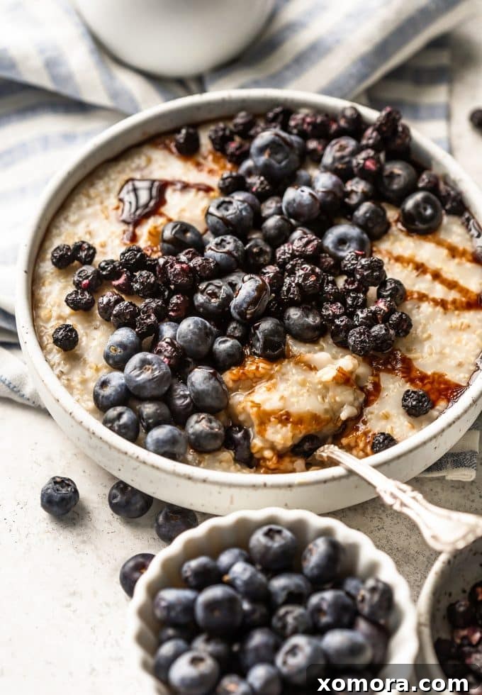 Creamy steel cut oats topped with fresh blueberries, freeze-dried blueberries, and a drizzle of date syrup.