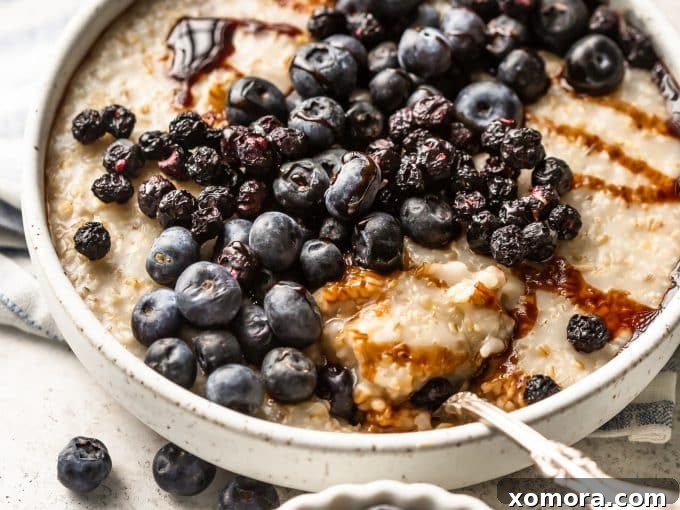 Cooked steel cut oats in a saucepan, ready for toppings.