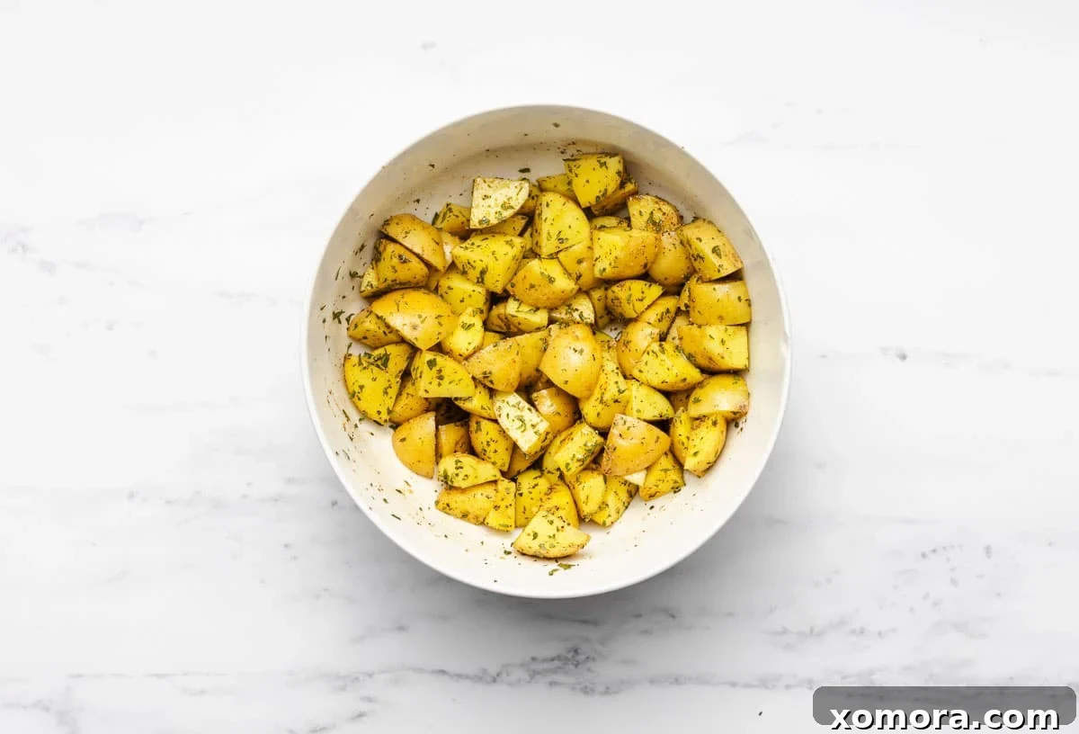 Golden Air Fryer Potato Bites 3 Close up of crispy air fryer potatoes in an air fryer basket