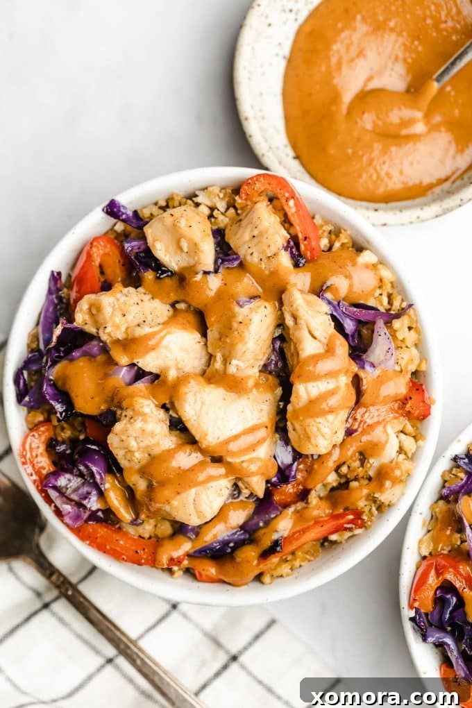 Peanut Satay Chicken Cauliflower Power Bowls 3 Close-up of roasted vegetables: cauliflower rice, red cabbage, and bell pepper.