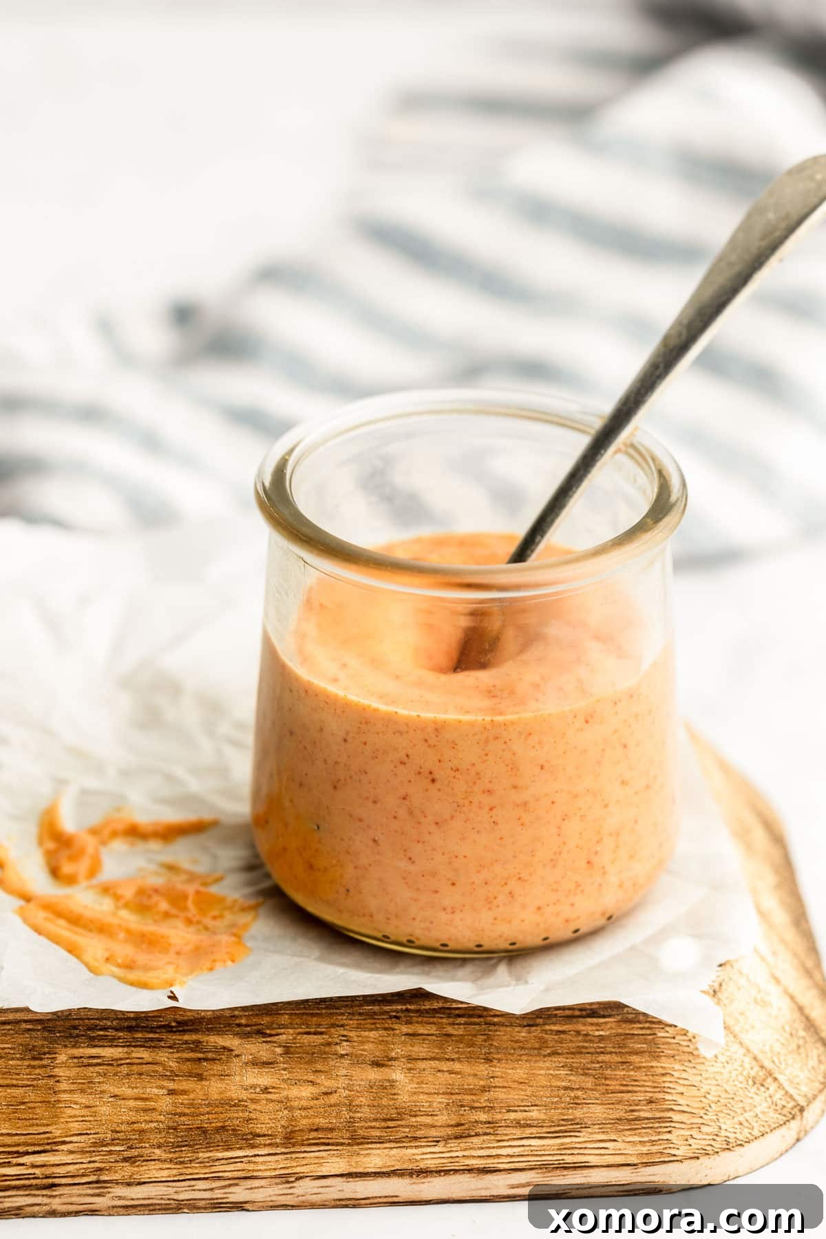 The Ultimate Homemade Mississippi Comeback Sauce 2 A jar of homemade Mississippi Comeback Sauce with fresh ingredients in the background.