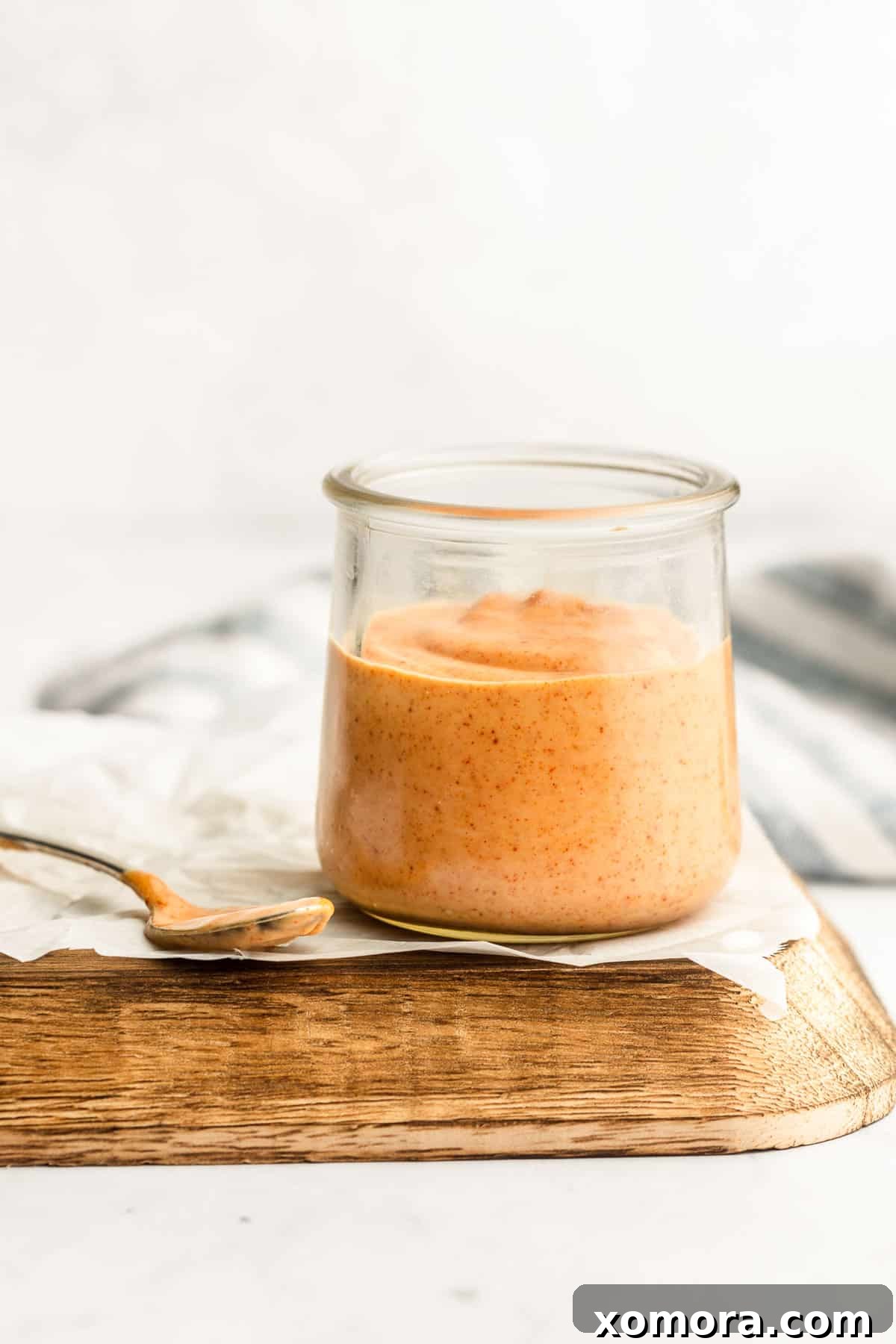 The Ultimate Homemade Mississippi Comeback Sauce 5 A person dipping a chicken tender into a bowl of Mississippi Comeback Sauce.