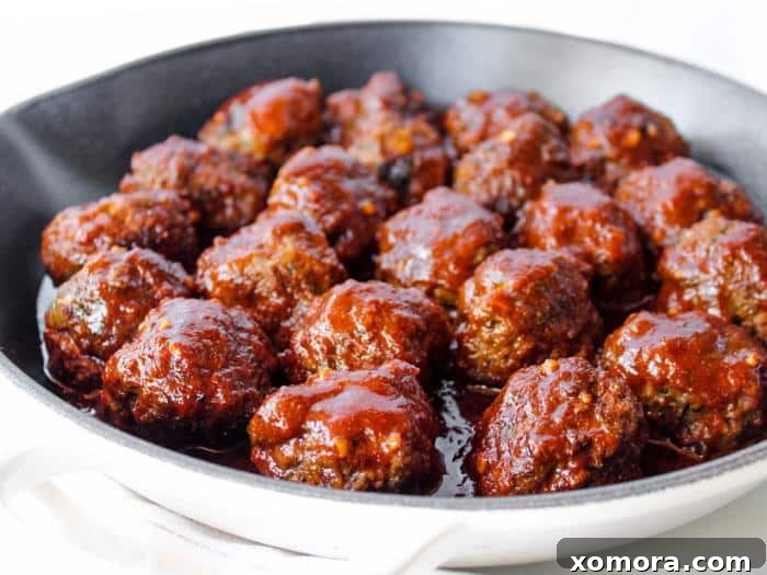 BBQ Glazed Meatballs 3 Close-up of a Barbecue Meatball on a fork, showing the rich, glossy sauce and tender texture.