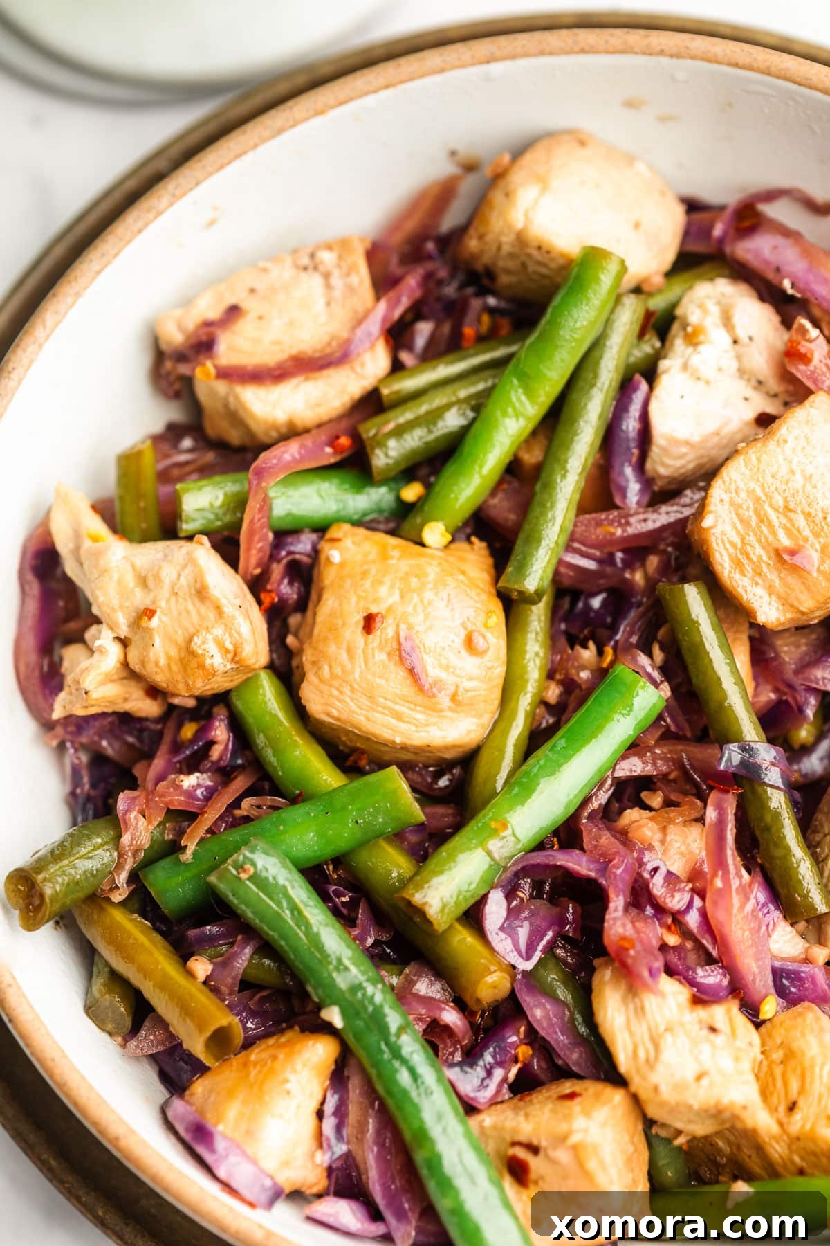 Quick Chicken Green Bean Stir Fry 6 Individual serving of Chicken Green Bean Stir Fry in a bowl