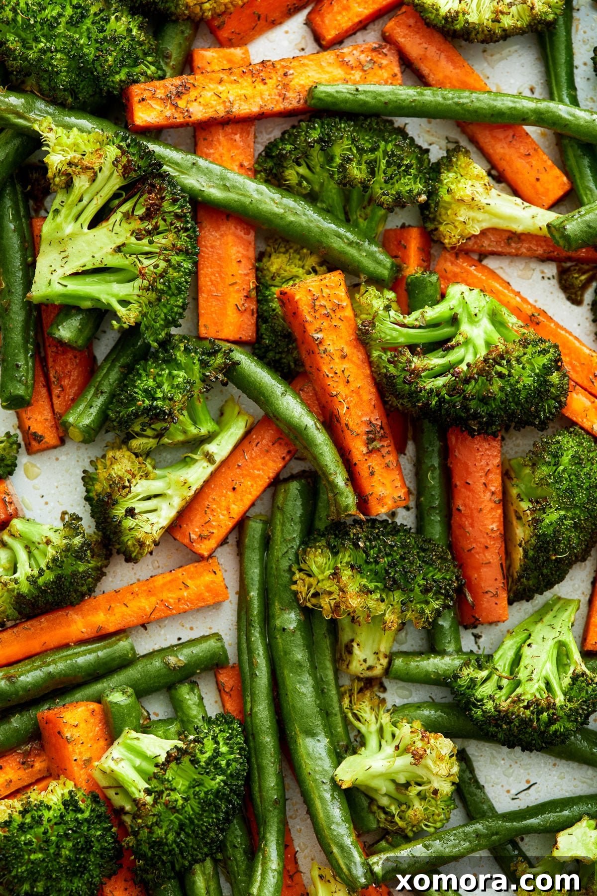 Ranch Roasted Vegetable Medley 2 Close-up of freshly roasted ranch vegetables, showing carrots, broccoli, and green beans with visible seasoning