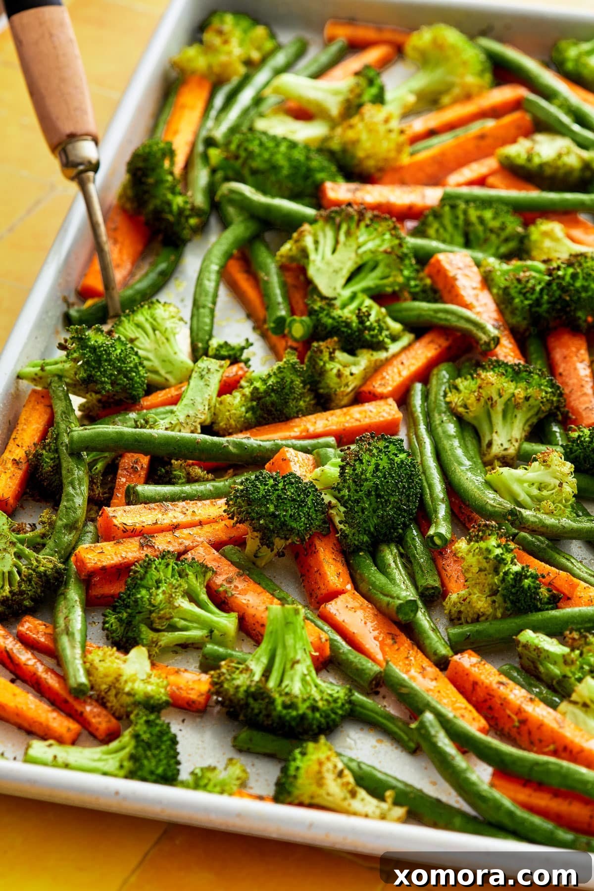 Ranch Roasted Vegetable Medley 5 A close-up of a large baking sheet filled with perfectly roasted ranch vegetables, showing crispy edges and tender interiors