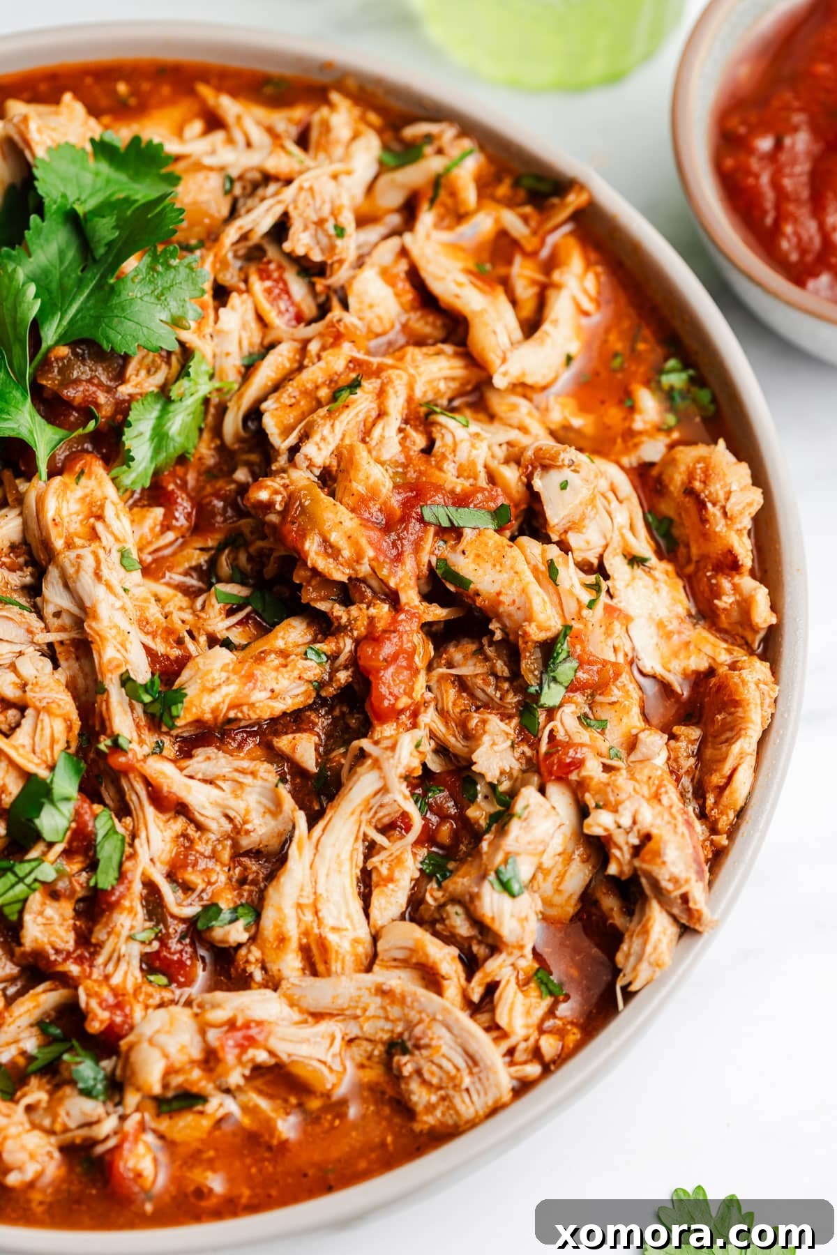 Effortless Instant Pot Shredded Salsa Chicken 5 A close-up of shredded salsa chicken in the Instant Pot, soaking in its juices.