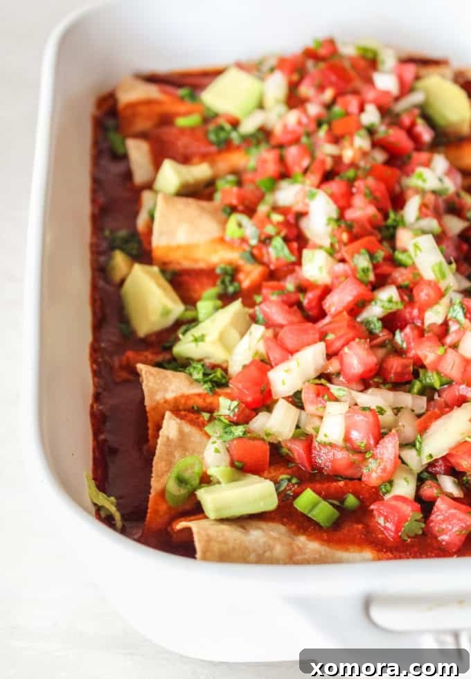 Unbelievably Creamy Dairy-Free Chicken Enchiladas 2 Delicious dairy-free chicken enchiladas baking in a dish.