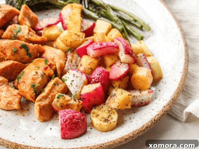 One-Pan Roasted Chicken and Broccolini 3 A vibrant mix of roasted broccolini, parsnips, and halved radishes on a baking sheet, showcasing their appealing colors and textures.