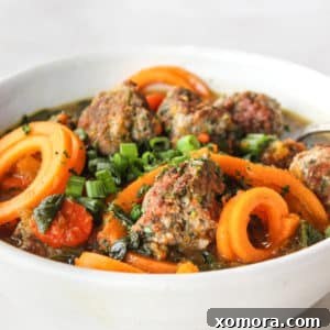 A beautiful shot of the final Turkey Meatball & Butternut Squash Soup in a bowl, ready to be enjoyed.