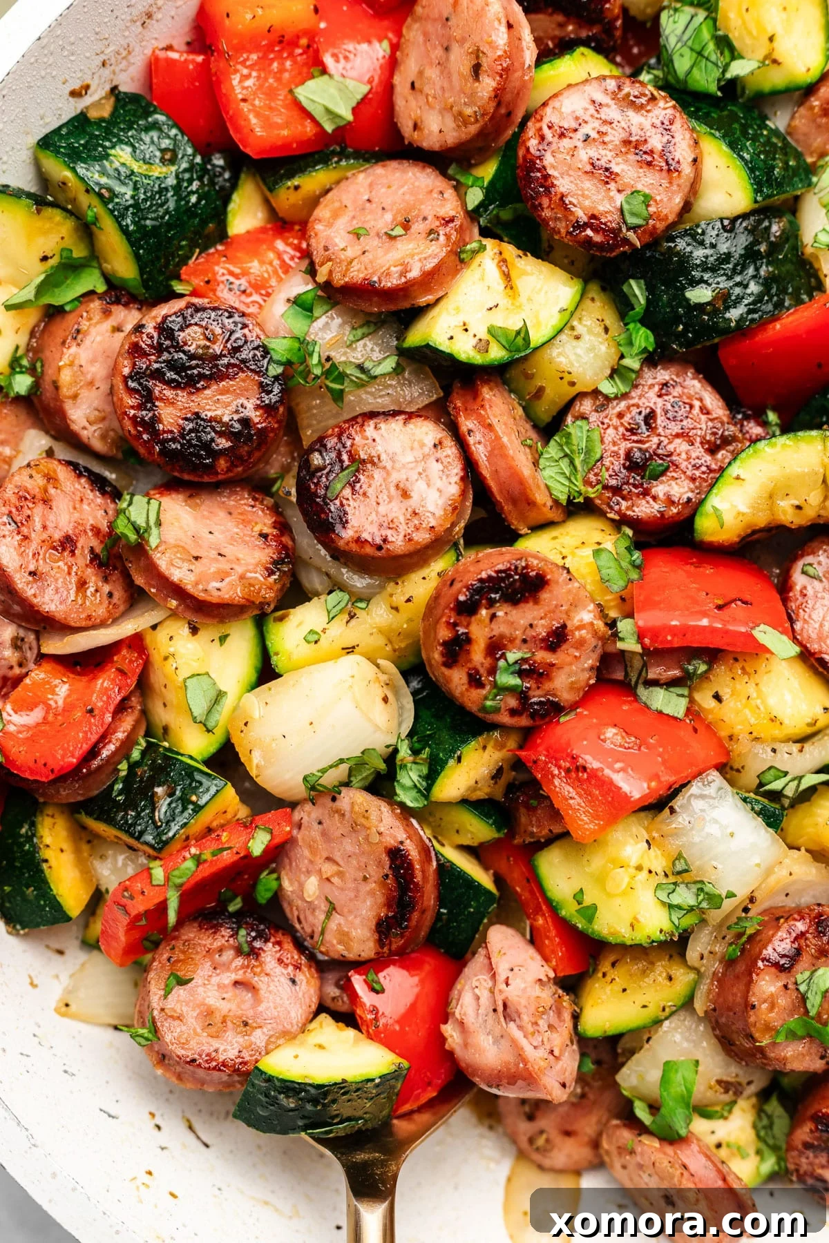 One-Pan 20-Minute Sausage and Zucchini Meal 2 A close-up shot of the finished sausage and zucchini skillet, showcasing browned sausage slices and tender, colorful vegetables.