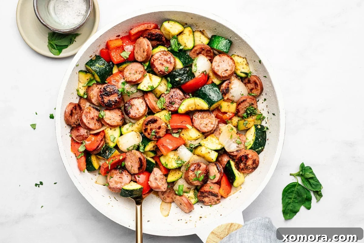 One-Pan 20-Minute Sausage and Zucchini Meal 5 A serving of the 20 Minute Sausage and Zucchini Skillet, garnished with fresh basil leaves.