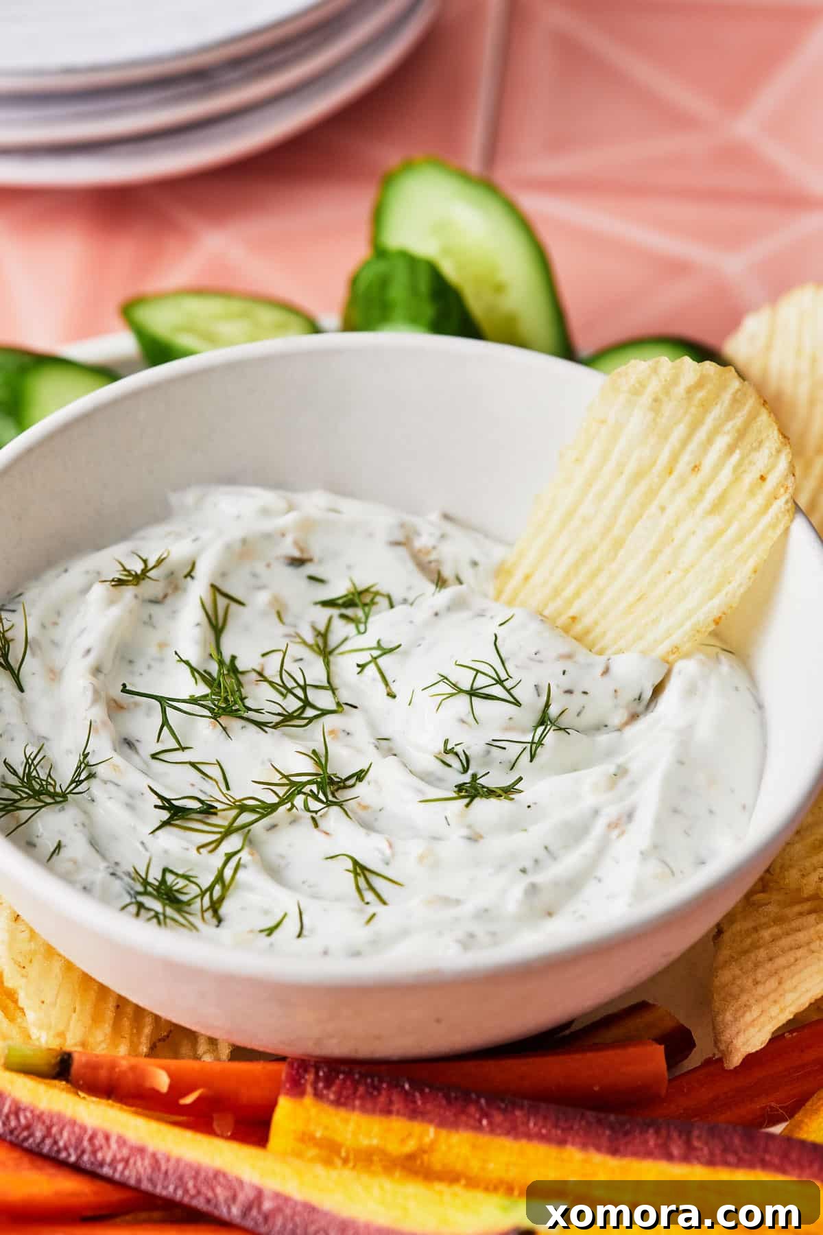 Guilt-Free French Onion Yogurt Dip 5 Overhead shot of French onion dip in a bowl surrounded by potato chips, ready for serving.