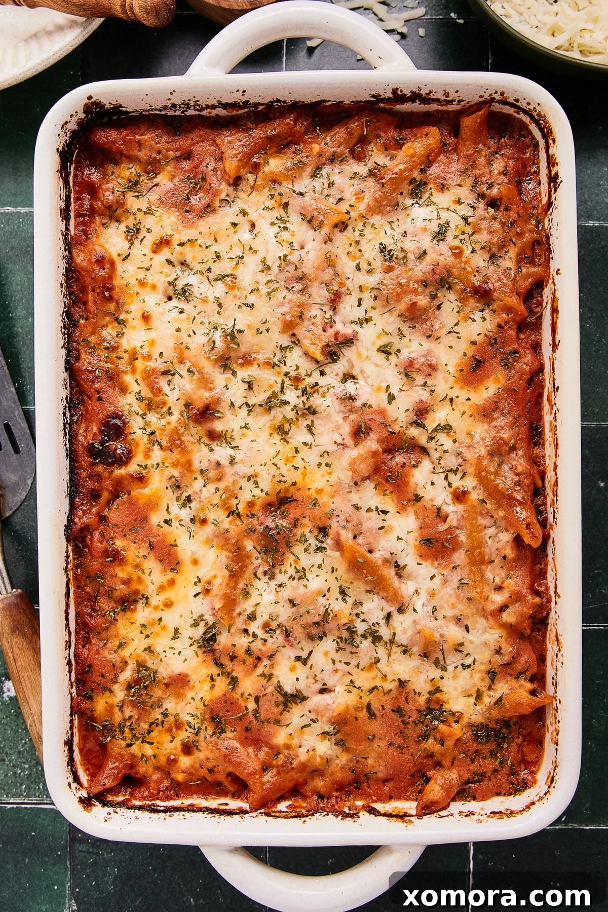 A perfectly baked Lazy Lasagna Penne Bake, showcasing the golden-brown cheese topping and hearty pasta within a baking dish.