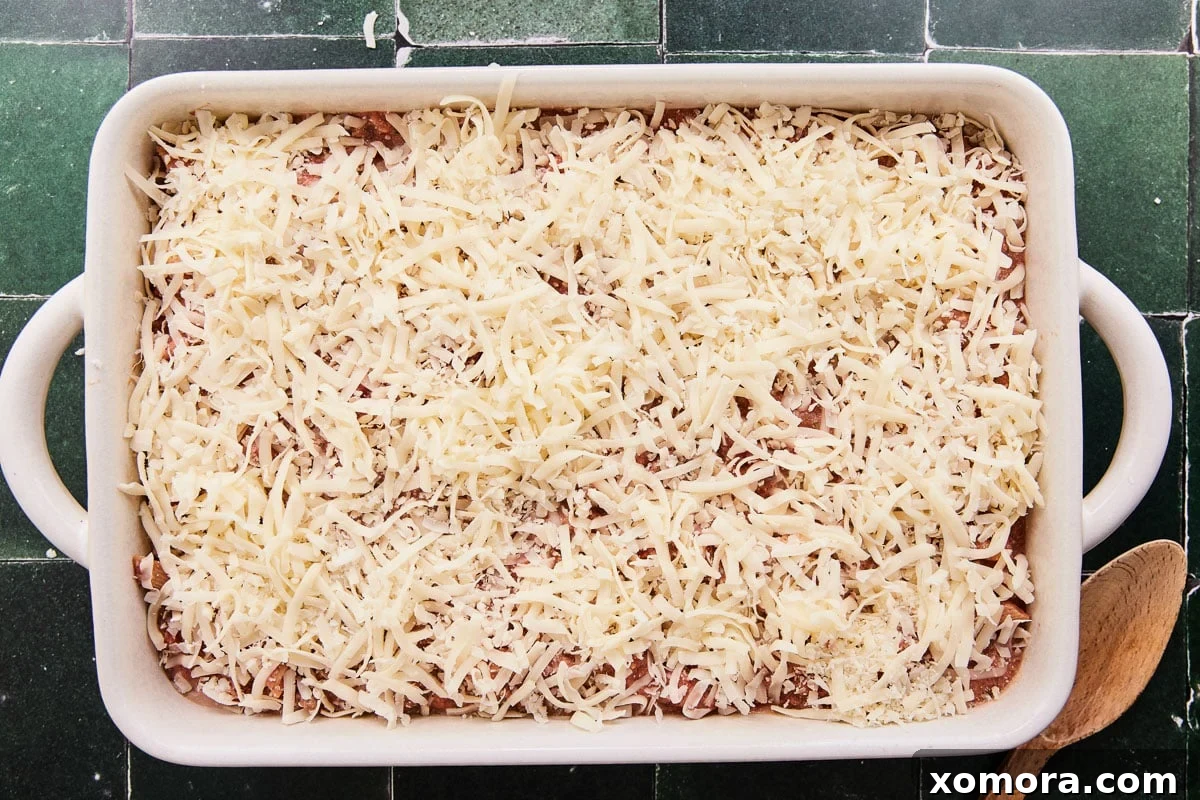 A serving of the Lazy Lasagna Penne Bake scooped out onto a plate, showing the rich sauce, penne pasta, and melted cheese.