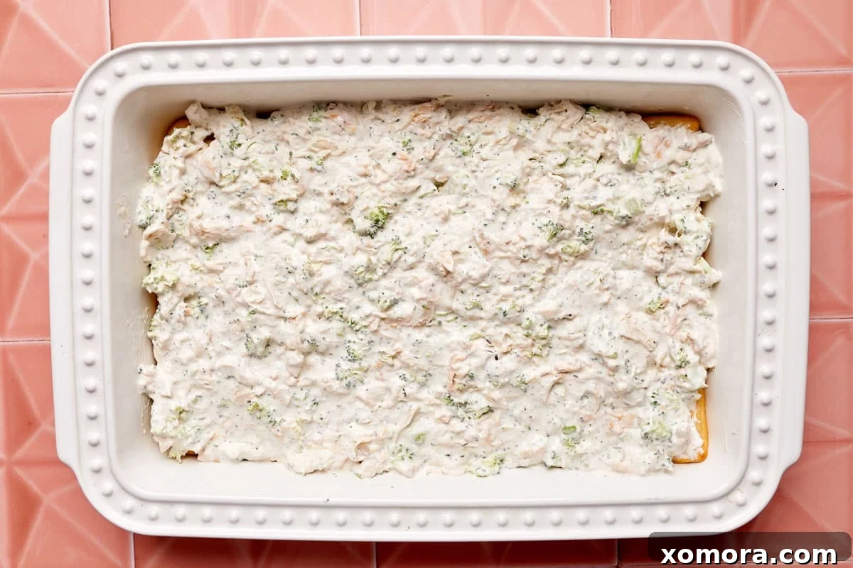 Creamy Chicken Broccoli Crescent Bake 5 The creamy chicken and broccoli casserole baking in the oven, with the cheese melting and bubbling to golden perfection.