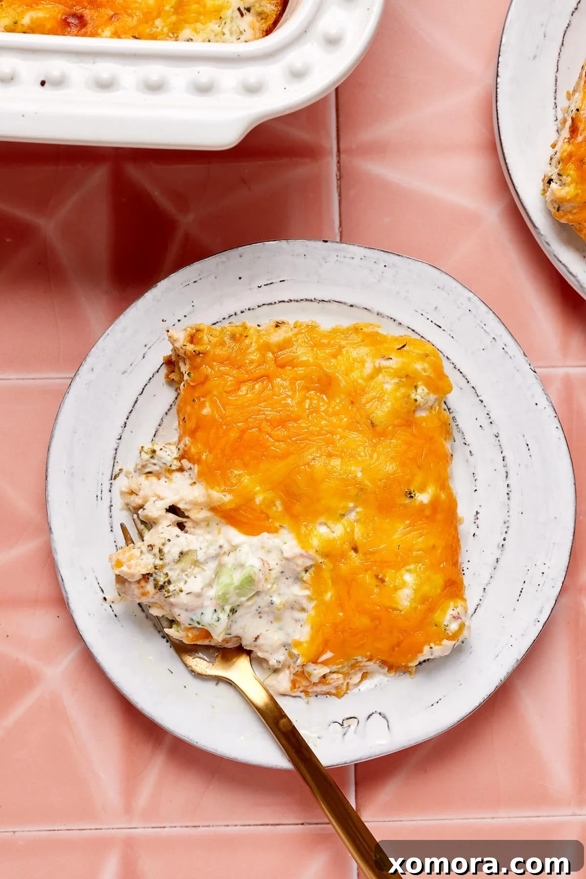 Creamy Chicken Broccoli Crescent Bake 7 A single, generous serving of creamy chicken and broccoli crescent roll casserole on a plate, with steam gently rising, highlighting its warmth and comfort.