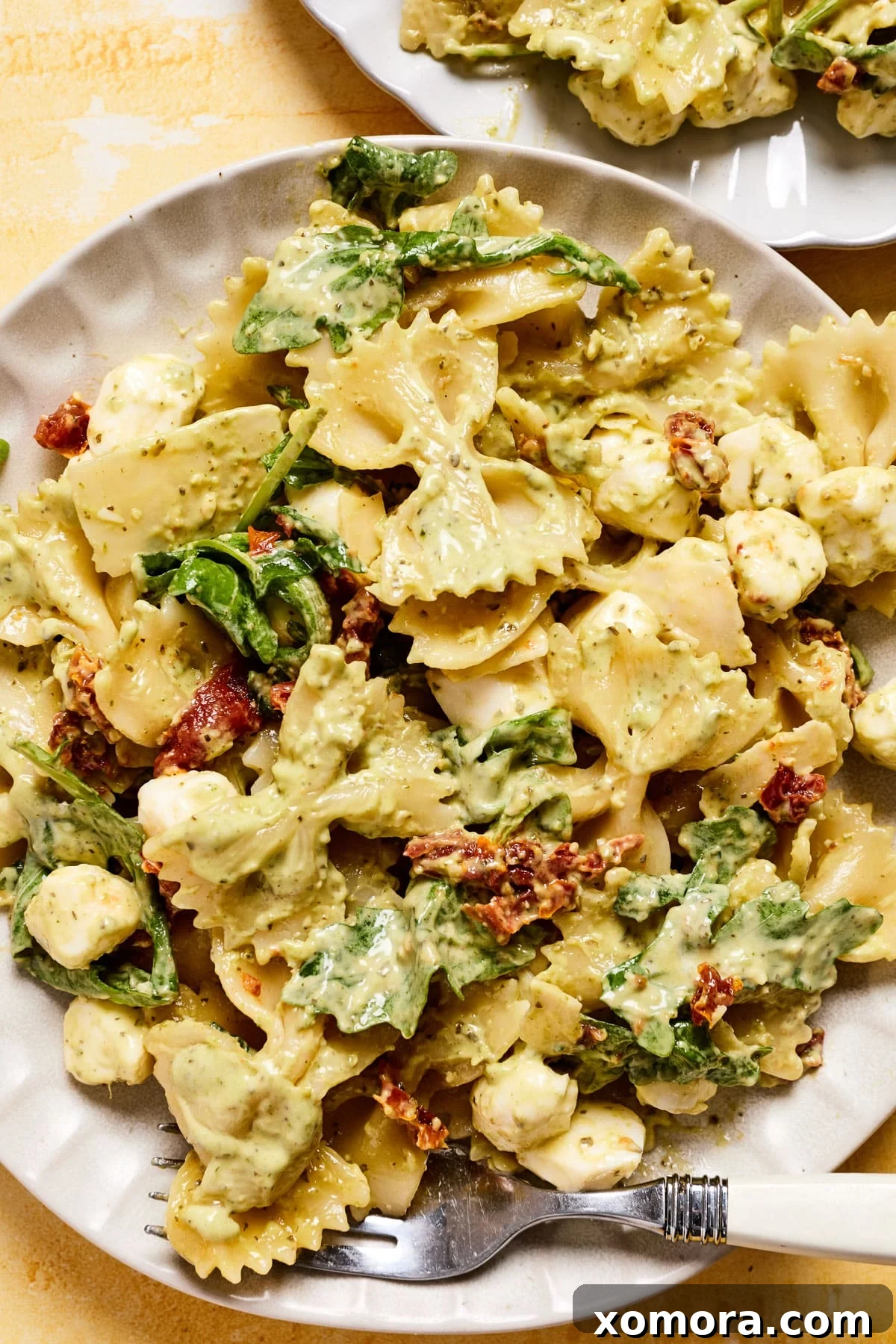 Make-Ahead Creamy Pesto Pasta Salad 2 Creamy pesto pasta salad with sun-dried tomatoes and mozzarella