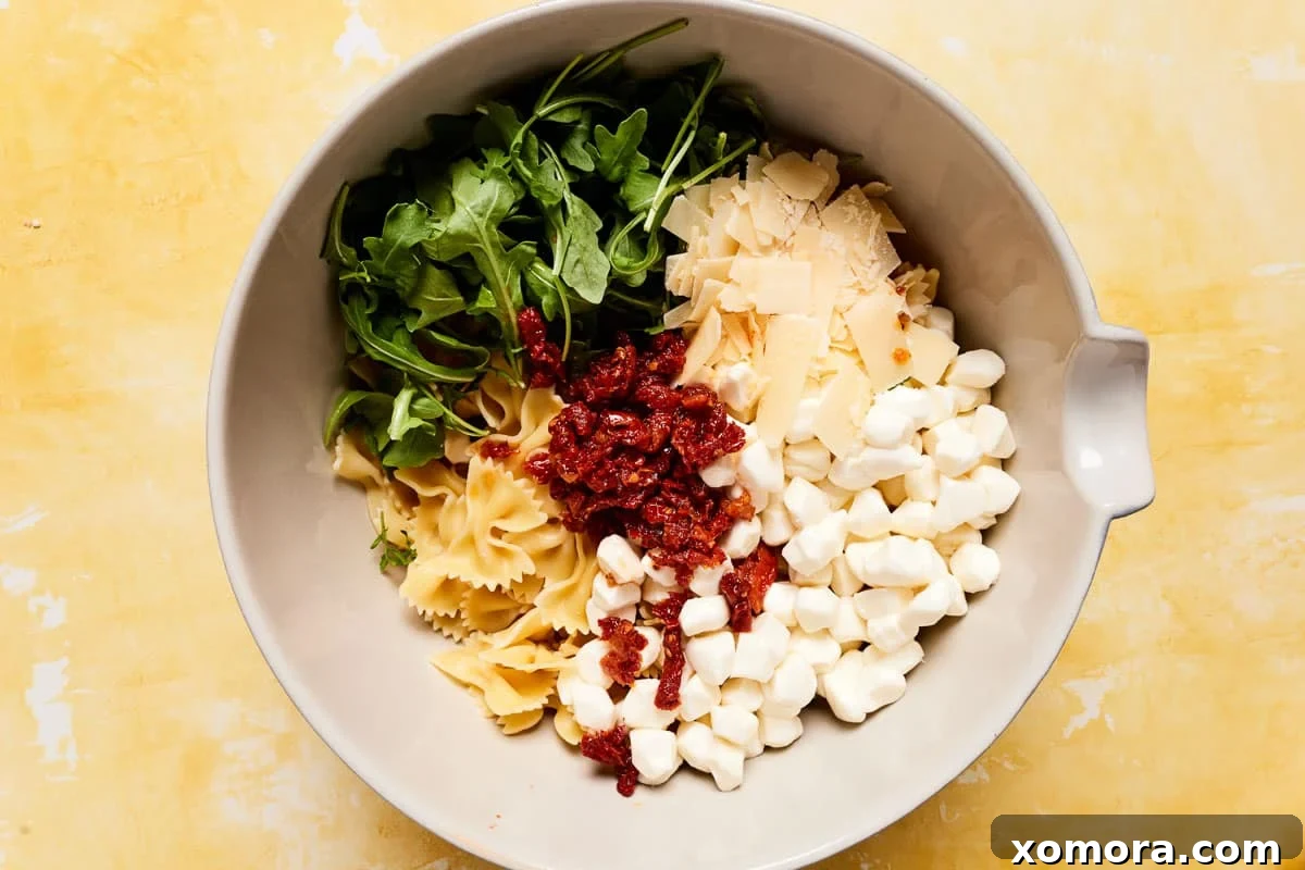 Make-Ahead Creamy Pesto Pasta Salad 3 Bowl of pesto pasta salad with arugula and cheese
